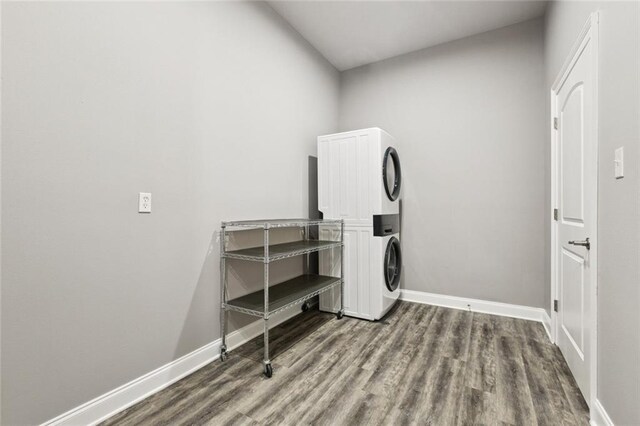 1400 Woodland Hwy, Belle Chasse, LA 70037 - washroom featuring stacked washer and clothes dryer, baseboards, and wood finished floors