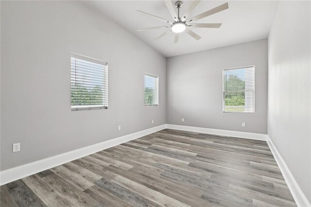 1400 Woodland Hwy, Belle Chasse, LA 70037 - empty room featuring wood finished floors, lofted ceiling, baseboards, and ceiling fan