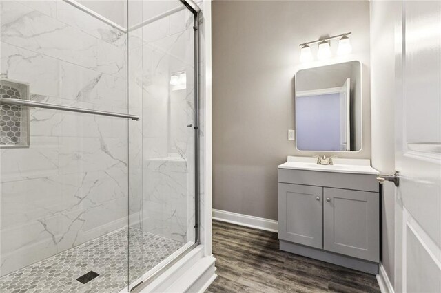 1400 Woodland Hwy, Belle Chasse, LA 70037 - bathroom featuring a marble finish shower, vanity, baseboards, and wood finished floors