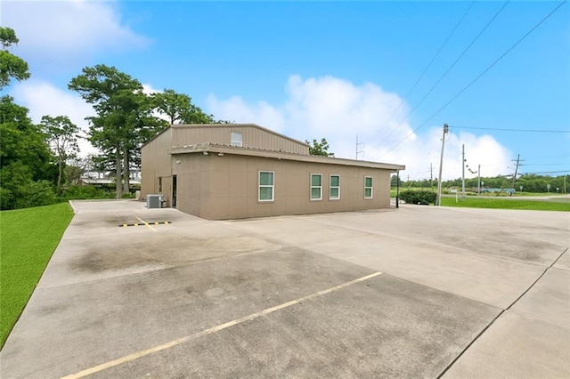 1400 Woodland Hwy, Belle Chasse, LA 70037 - view of property exterior with uncovered parking and central air condition unit