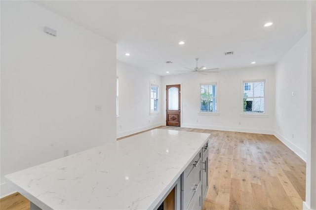 2509 Palmyra St, New Orleans, LA 70119 - kitchen featuring light wood finished floors, ceiling fan, recessed lighting, light stone counters, and open floor plan