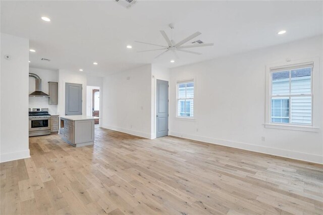 2509 Palmyra St, New Orleans, LA 70119 - unfurnished living room with light wood-type flooring, ceiling fan, and recessed lighting
