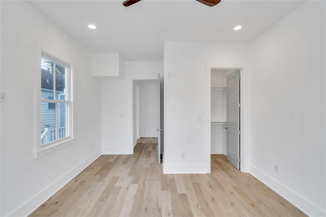 2509 Palmyra St, New Orleans, LA 70119 - unfurnished bedroom featuring light wood finished floors, a spacious closet, recessed lighting, ceiling fan, and a closet