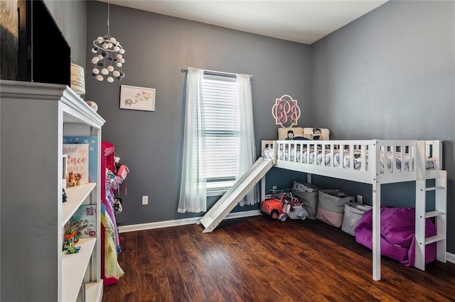 290 Blakemore Dr, Ponchatoula, LA 70454 - bedroom with wood finished floors, a nursery area, and a chandelier