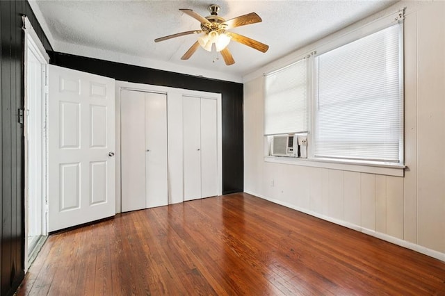 3500 Clematis St, New Orleans, LA 70123 - unfurnished bedroom featuring hardwood / wood-style flooring, multiple closets, cooling unit, and ceiling fan