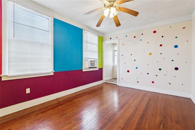 3500 Clematis St, New Orleans, LA 70123 - empty room with hardwood / wood-style flooring, healthy amount of natural light, a ceiling fan, cooling unit, and a textured ceiling