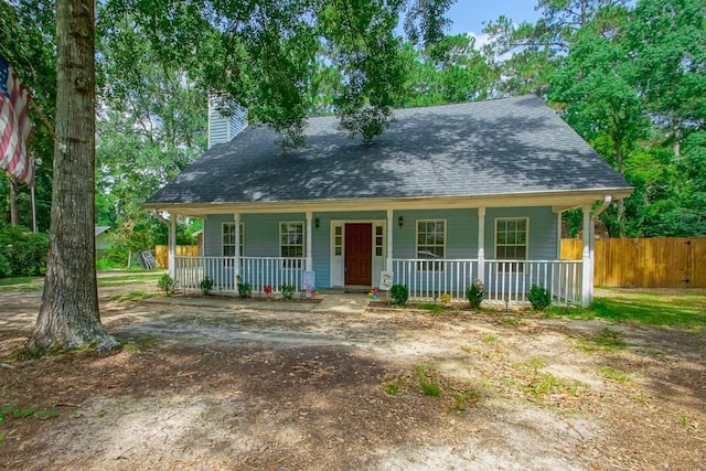 70380 K St, Covington, LA 70433 - view of front of property with covered porch, a chimney, and a shingled roof