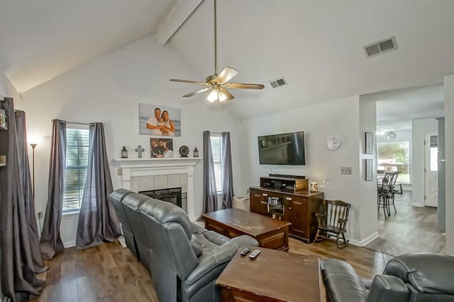 70380 K St, Covington, LA 70433 - living room featuring ceiling fan, wood finished floors, beam ceiling, a tile fireplace, and high vaulted ceiling
