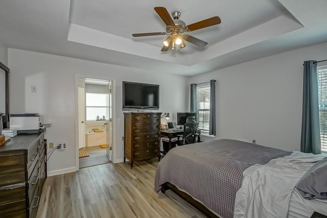 70380 K St, Covington, LA 70433 - bedroom with a tray ceiling, light wood-style flooring, ceiling fan, and ensuite bathroom