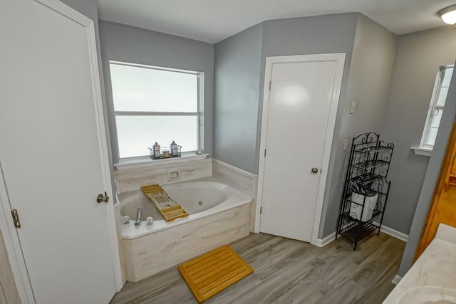 70380 K St, Covington, LA 70433 - full bathroom featuring a tub with jets, wood finished floors, and vanity