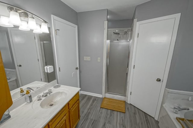 70380 K St, Covington, LA 70433 - bathroom with vanity, a stall shower, wood finished floors, and a tub to relax in