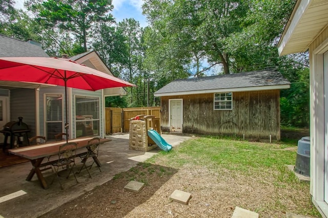 70380 K St, Covington, LA 70433 - view of yard featuring an outbuilding and a patio area