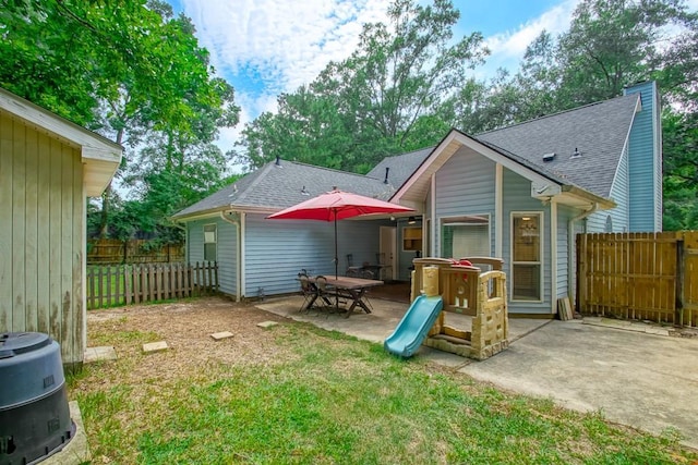 70380 K St, Covington, LA 70433 - back of house featuring a patio and a shingled roof
