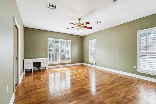 175 Dunleith Dr, Destrehan, LA 70047 - unfurnished room featuring a ceiling fan, healthy amount of natural light, and wood finished floors