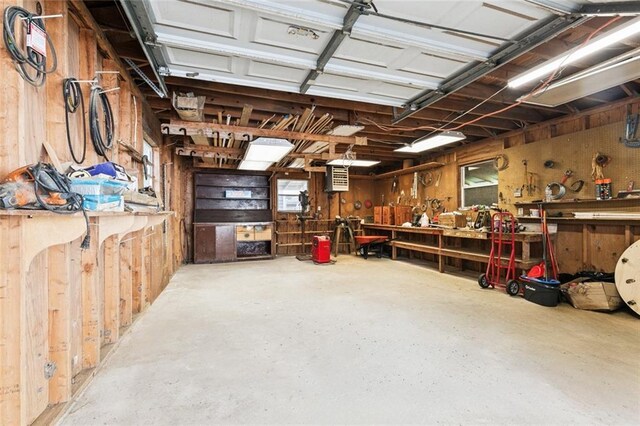 175 Dunleith Dr, Destrehan, LA 70047 - garage with a workshop area and wooden walls