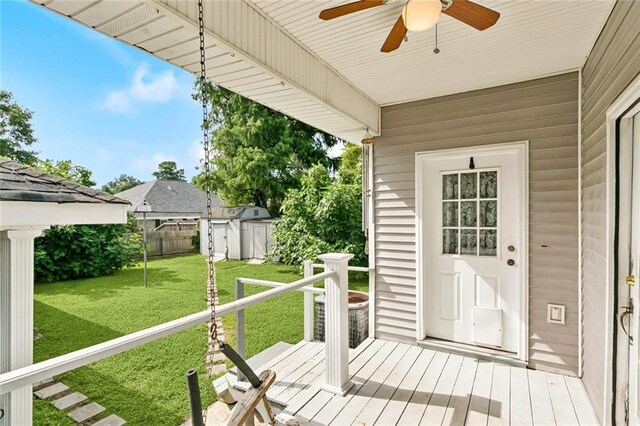175 Dunleith Dr, Destrehan, LA 70047 - wooden terrace featuring a storage shed, ceiling fan, and a fenced backyard