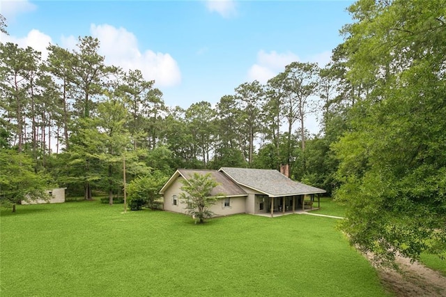 20226 Chandler Dr, Covington, LA 70435 - rear view of house featuring a chimney, a yard, view of scattered trees, and a patio