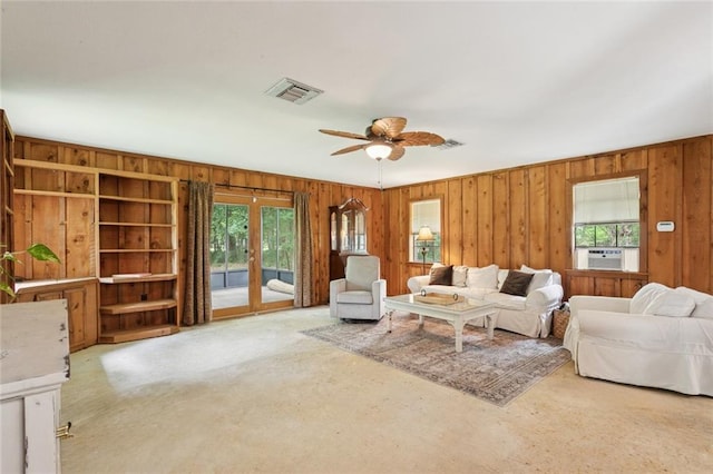 20226 Chandler Dr, Covington, LA 70435 - living area with wood walls, a ceiling fan, carpet, cooling unit, and french doors