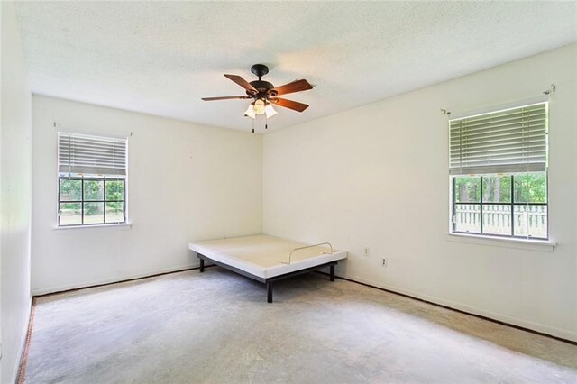 20226 Chandler Dr, Covington, LA 70435 - spare room with ceiling fan, concrete flooring, and a textured ceiling