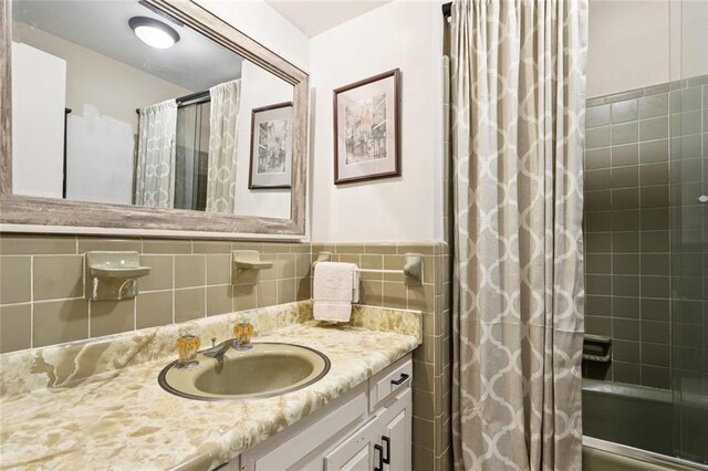 20226 Chandler Dr, Covington, LA 70435 - bathroom with vanity, tile walls, shower / bathtub combination with curtain, and wainscoting