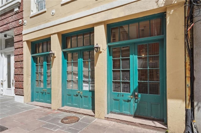 214 Chartres St Unit 3, New Orleans, LA 70130 - entrance to property with french doors and stucco siding