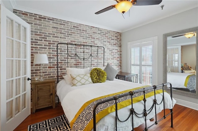 214 Chartres St Unit 3, New Orleans, LA 70130 - bedroom with brick wall, wood finished floors, ornamental molding, and a ceiling fan