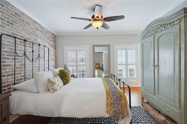 214 Chartres St Unit 3, New Orleans, LA 70130 - bedroom with brick wall, wood finished floors, ornamental molding, and a ceiling fan