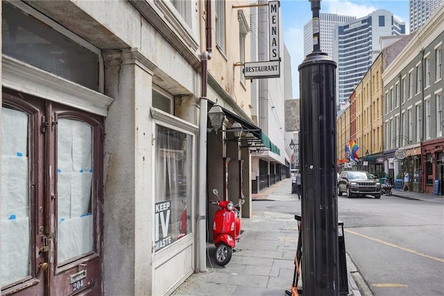 214 Chartres St Unit 3, New Orleans, LA 70130 - view of asphalt street with sidewalks, street lights, and curbs