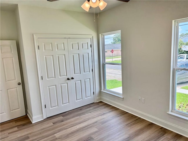 2035 Huey P Lng Ave, Gretna, LA 70053 - unfurnished bedroom with light wood-type flooring, a closet, and multiple windows