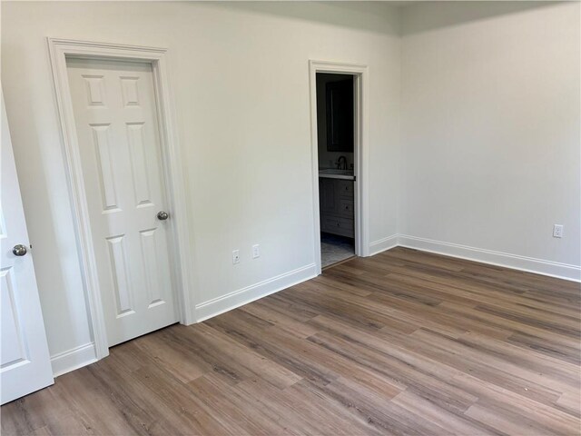 2035 Huey P Lng Ave, Gretna, LA 70053 - unfurnished bedroom featuring wood finished floors and ensuite bathroom