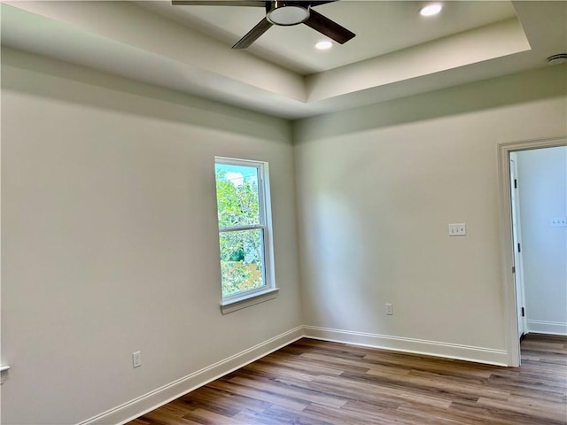 2035 Huey P Lng Ave, Gretna, LA 70053 - spare room with dark wood-style flooring, a raised ceiling, a ceiling fan, and recessed lighting