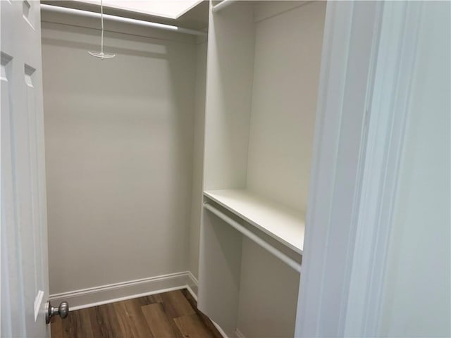 2035 Huey P Lng Ave, Gretna, LA 70053 - walk in closet with dark wood-style flooring