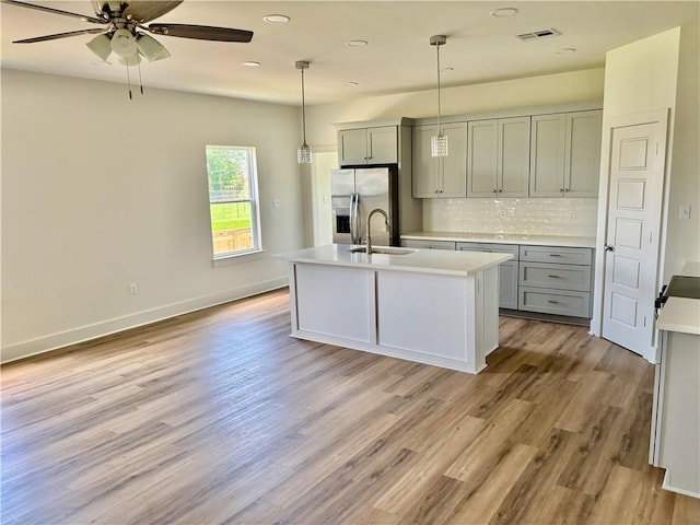 2444 Huey P Long Ave, Gretna, LA 70053 - kitchen featuring stainless steel fridge with ice dispenser, gray cabinets, light countertops, backsplash, and recessed lighting