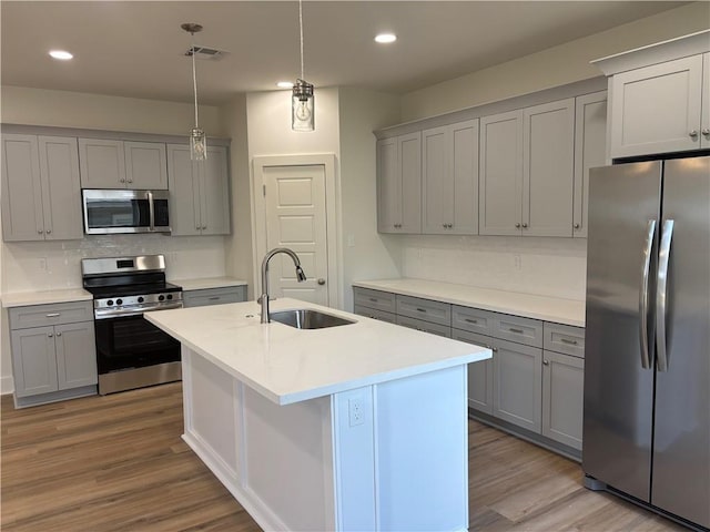 2019 Huey P Long Ave, Gretna, LA 70053 - kitchen with stainless steel appliances, gray cabinets, backsplash, wood finished floors, and recessed lighting