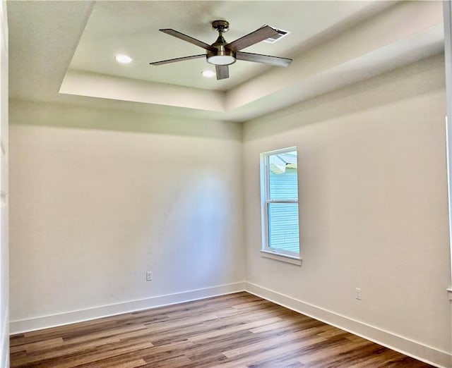 2019 Huey P Long Ave, Gretna, LA 70053 - spare room featuring a tray ceiling, wood finished floors, a ceiling fan, and recessed lighting