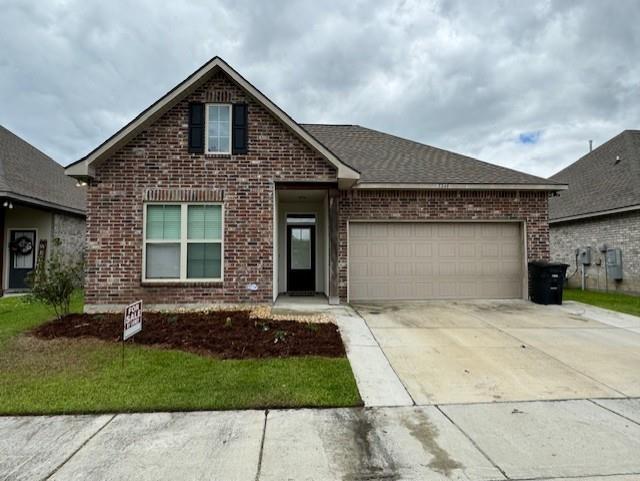 7248 Kenilworth Crossing Ave, Baton Rouge, LA 70820 - traditional home with brick siding, concrete driveway, and a garage