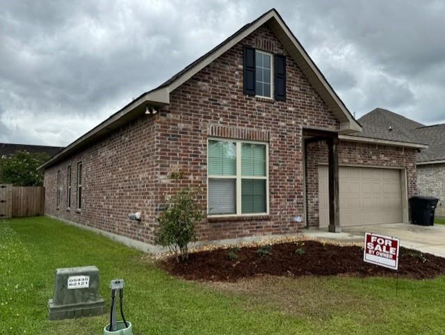 7248 Kenilworth Crossing Ave, Baton Rouge, LA 70820 - view of front of property with brick siding, a garage, and driveway