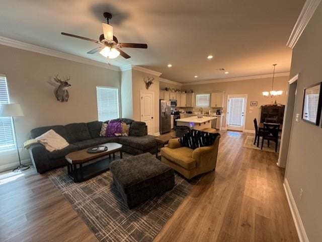 7248 Kenilworth Crossing Ave, Baton Rouge, LA 70820 - living area featuring wood finished floors, a chandelier, ornamental molding, a ceiling fan, and recessed lighting