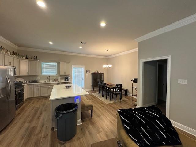 7248 Kenilworth Crossing Ave, Baton Rouge, LA 70820 - kitchen featuring stainless steel refrigerator with ice dispenser, a chandelier, a center island, light wood finished floors, and recessed lighting