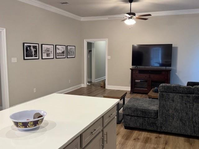 7248 Kenilworth Crossing Ave, Baton Rouge, LA 70820 - kitchen with wood finished floors, open floor plan, ornamental molding, ceiling fan, and light countertops