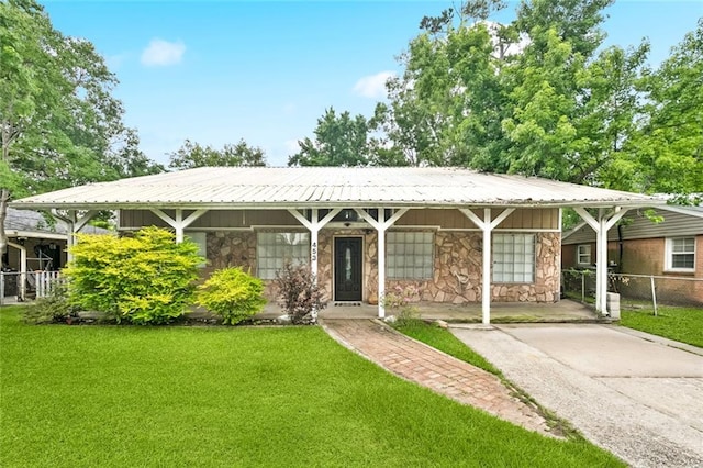 453 Olive Dr, Slidell, LA 70458 - single story home with stone siding, driveway, and a carport