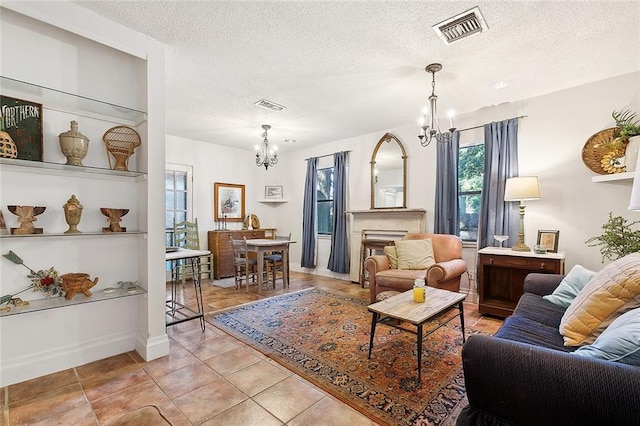 515 Sidney St, Metairie, LA 70005 - living area featuring a chandelier, light tile patterned flooring, and a textured ceiling