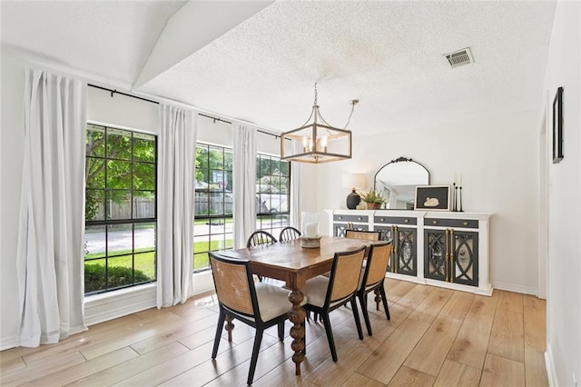 104 Inverrary Ct, Slidell, LA 70460 - dining area featuring a chandelier, light wood-style floors, and a textured ceiling