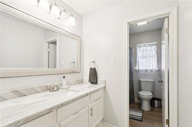 104 Inverrary Ct, Slidell, LA 70460 - full bathroom with vanity, wood finished floors, and a textured ceiling