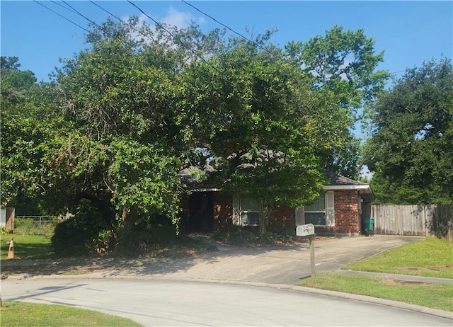 105 Parkbrook Cir, Slidell, LA 70460 - view of property hidden behind natural elements featuring brick siding and concrete driveway