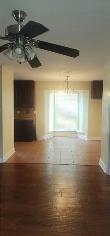 105 Parkbrook Cir, Slidell, LA 70460 - empty room with wood finished floors, ceiling fan, and a chandelier