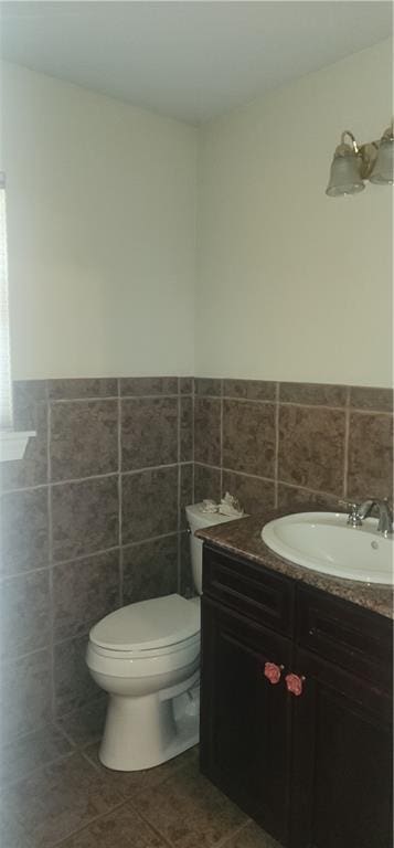 105 Parkbrook Cir, Slidell, LA 70460 - half bathroom with vanity, tile walls, tile patterned floors, and a wainscoted wall