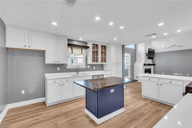 506 Ellington Ave, Luling, LA 70070 - kitchen featuring a ceiling fan, light wood-style floors, white cabinets, a kitchen island, and recessed lighting