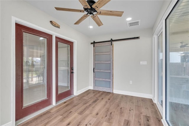 506 Ellington Ave, Luling, LA 70070 - unfurnished room featuring a barn door, light wood-style floors, a ceiling fan, and recessed lighting
