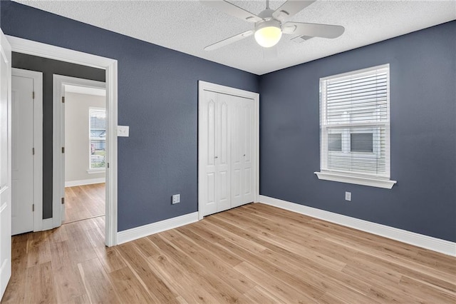 506 Ellington Ave, Luling, LA 70070 - unfurnished bedroom featuring a textured ceiling, light wood-type flooring, a closet, and a ceiling fan